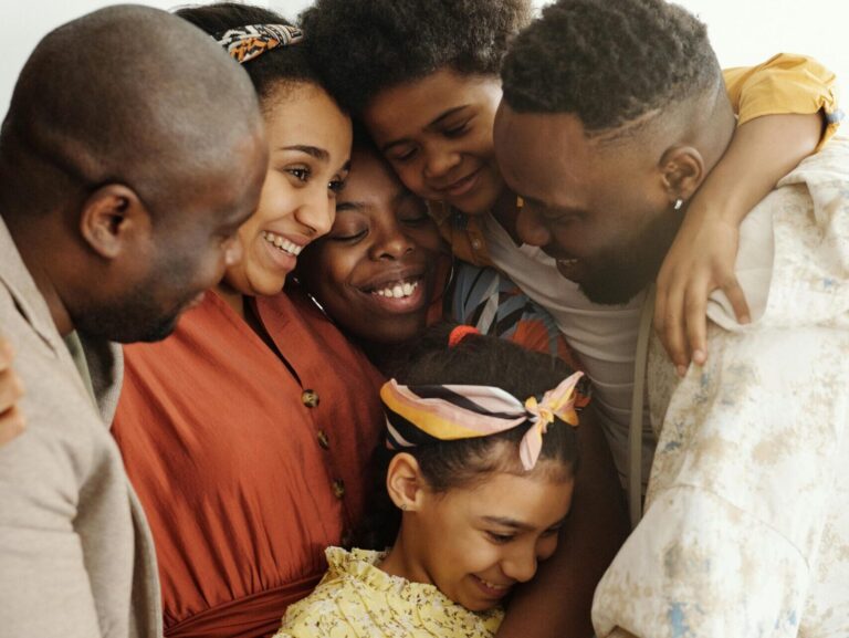 A joyful moment of family bonding captured in a warm embrace indoors.